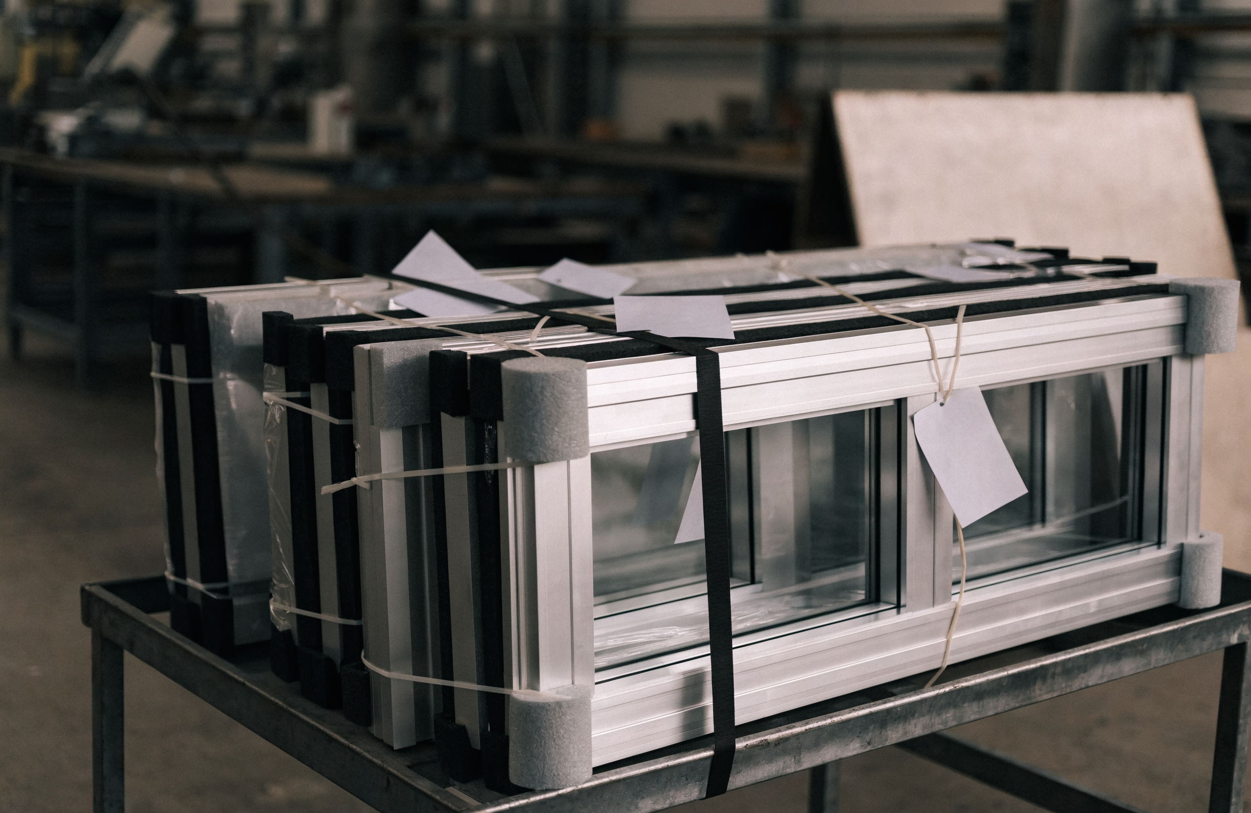 Finished fabricated aluminum storefront frames packed complete on a shipping cart